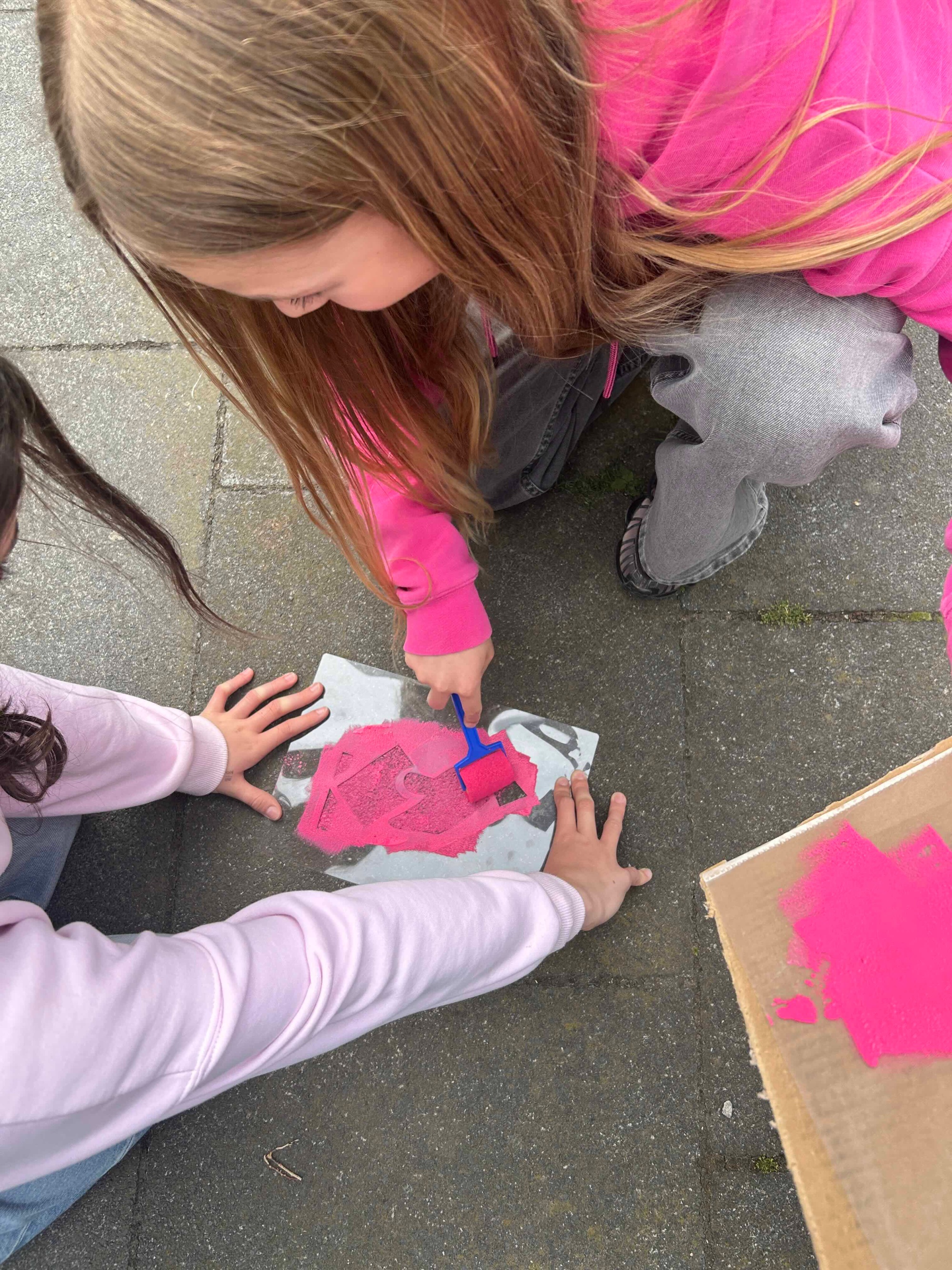 Schablone und Farbe, Kinderhände auf dem Gehweg
